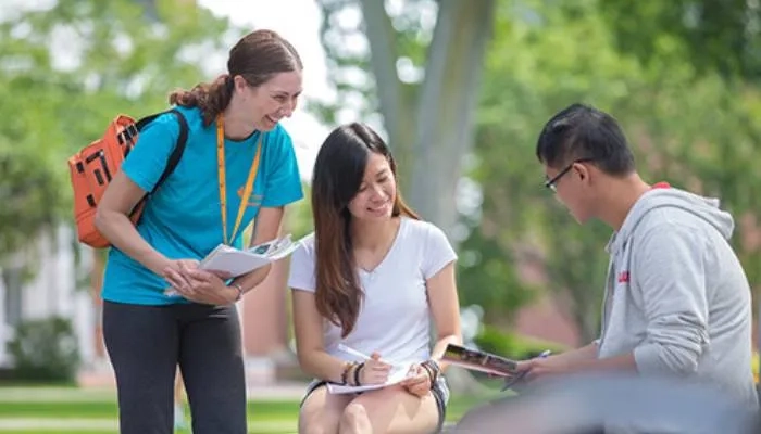 Employee helping students